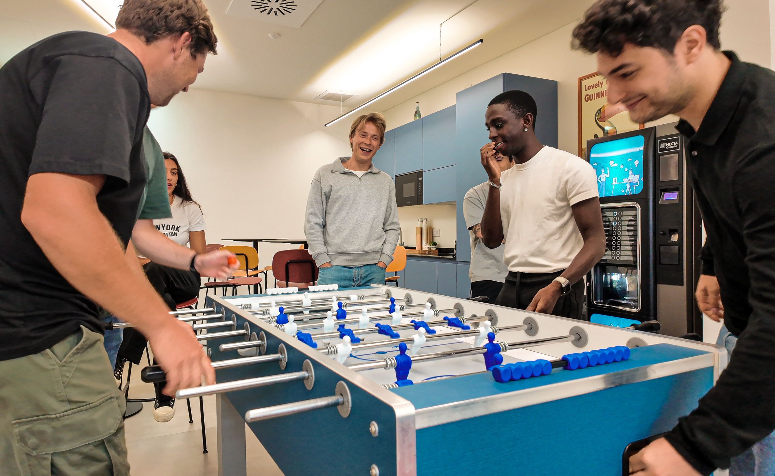 Dipendenti Promedital che giocano a biliardino nella sala relax aziendale